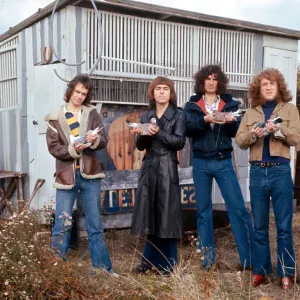 Slade holding pigeons By wooden hut shack shed Standing in the grass