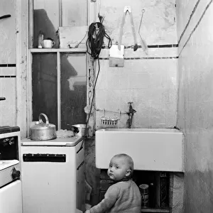 Slum housing in Salford. 1 year old boy Peter. Their home has two rooms up