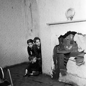 Slum housing in Salford. Brothers of the Logan family, Thomas, 9, John, 3, and Peter 7