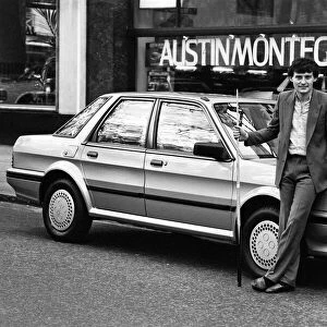 Snooker player Jimmy White poses beside a new model Austin Montego. 11th May 1984
