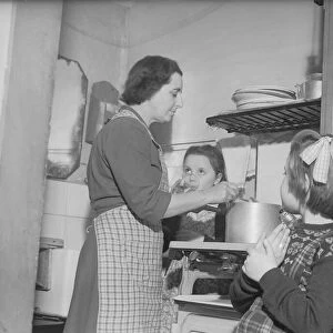 Stay at home mother Mrs Mary Mackenzie seen preparing the evening meal being watched by
