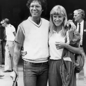 Sue Barker and Cliff Richard walking arm in arm during Wimbledon tournament - June 1983