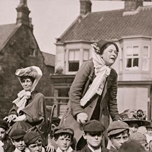 Suffragette Emmeline Pankhurst seated as Margaret Bondfield makes a speech Circa