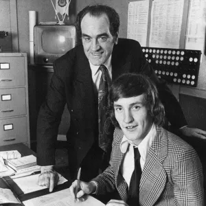 Terry McDermott signs for Newcastle United, watched by manager Joe Harvey