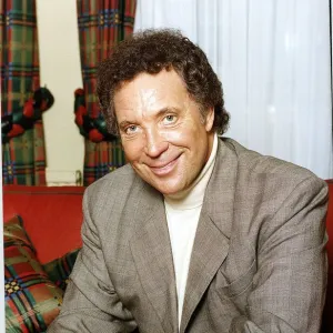 Tom Jones British singer Sitting on a red couch