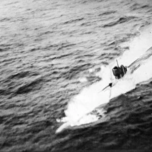 A U-boat in the act of crash diving following interception by Liberator aircraft