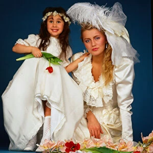 Wedding dress fashion, February 1987 model wearing wedding dress sitting ground