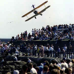 A wing walker performs on the Cadburys Crunchie Boeing-Stearman Model 75 biplane at