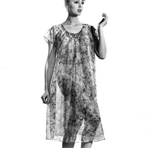 Woman wearing flowered nightdress. Reveille Fashions. Yvette Davies. April 1962 P008845