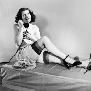 Woman wearing stockings seen here on the telephone