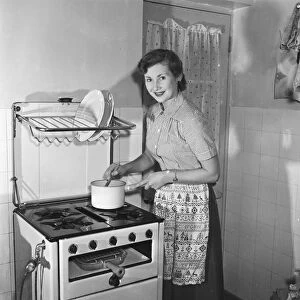 Women in kitchen. Circa 1952