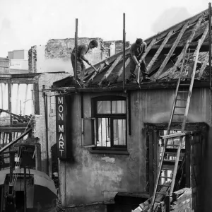 Workmen busy demolishing old property in Queen Street, Cardiff. 6th April 1960