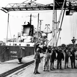 Workmen from Garston Stevedores lifting their hats to the success of their company