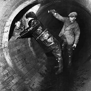 Workmen inspect the underground sewer tunnel that extends from under the Mersey tunnel