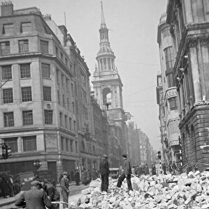 Workmen sift through the debris following the previous nights air raid on Central London