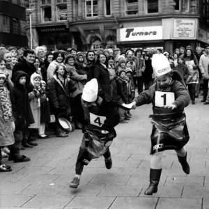 Two youngsters battle it out in the Shrove Tuesday Pancake race at Grey