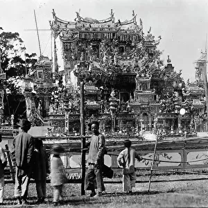Some people at Amoy observe a float depicting a temple