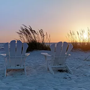Florida, Saint Petersburg Beach, beach chairs on sand at sunset