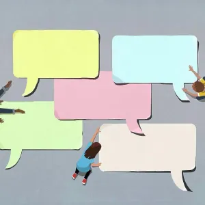 Kids arranging blank multicolor speech bubbles
