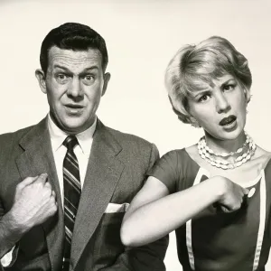 Portrait of a young couple pointing to themselves