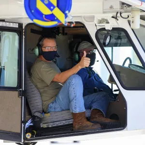 Ryan Kiechle of Jacobs Technology gives a thumbs-up inside the transporter with Orion secured atop as the spacecraft