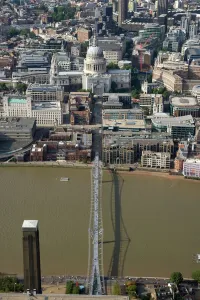 Prints of MILLENNIUM BRIDGE, London. An aerial view of the bridge and St Pauls Cathedral. The pedestrian walkway connects the City and Southwark across the River Thames Bridge Prints: Millennium Bridge Print: Aerial View of London