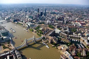 Prints of TOWER BRIDGE, London. An aerial view of the bridge, River Thames, Tower of London and the City from the south east Bridge Prints: Tower Bridge Print: Aerial View of London
