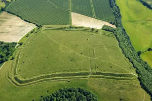 Prints of Hod Hill, an Iron Age multivallate hillfort earthwork, with a Roman fort earthwork in top lefthand corner, near Stourpaine, Dorset, 2022 Aerial Views of England - Landscapes, Cities and Heritage from Above: Hod Hill Print: Iron Age hillfort with Roman fort earthwork