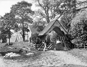 <b class=qtipBold><figcaption>Aldworth lychgate CC72_01073</figcaption></b><br>ST MARYS CHURCH, Aldworth, Berkshire. Looking towards the church which is visible through the trees with a woman passing through the lychgate in the foreground. Photographed in 1895 by Henry Taunt. <br><em>© Historic England</em> Aldworth lychgate CC72_01073