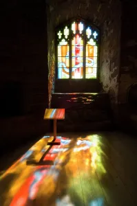 Prints of GOODRICH CASTLE, Herefordshire. Interior view of the Chapel. Stained glass window with light flooding lecturn and floor Herefordshire Prints: Goodrich Castle Chapel Print: Interior Stained Glass Window