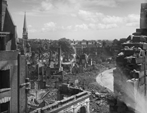 <b class=qtipBold><figcaption>Bomb damage, Exeter BB42_00707</figcaption></b><br>Exeter, Devon. Bomb damage on the north side of Bedford Circus looking towards Southernhay and the spire of Southernhay Congregational Church. The Margaret Tomlinson negative register records that the damage visible in this photograph was the result of a German air raid on 4th May 1942.<br><em>© Historic England Archive</em> Bomb damage, Exeter BB42_00707