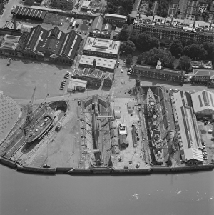 <b class=qtipBold><figcaption>Chatham Naval Dockyard 21303_10</figcaption></b><br>Chatham Naval Dockyard, Kent. This aerial photograph shows the dry docks at Chatham Dockyard beside the River Thames. The site was first used in 1547, but its busiest period was in the 19th century when 2 ships every year were being launched. The dockyard closed in the 1980s and is now a museum. Photographed in July 2001.<br><em>© Historic England Archive</em> Chatham Naval Dockyard 21303_10