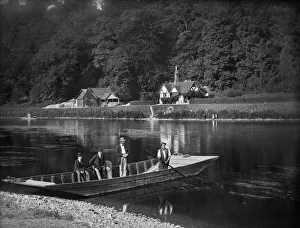 <b class=qtipBold><figcaption>Cliveden ferry CC72_01262</figcaption></b><br>CLIVEDEN FERRY, Cliveden, Taplow, Buckinghamshire. The ferryman is ready to take two men and a boy across the river. The man seated on the side of the boat holds a camera. The River Thames is wide and shallow at this point. Henry Taunt 1885.<br><em>© Historic England</em> Cliveden ferry CC72_01262