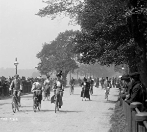 <b class=qtipBold><figcaption>Cycling in Hyde Park CC97_01239</figcaption></b><br>Hyde Park, Westminster, Greater London. A general view of both male and female cyclists in Hyde Park with spectators lining the route. York & Son, 1890s.<br><em>© Historic England</em> Cycling in Hyde Park CC97_01239