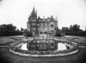 Prints of Eaton Hall, Cheshire. The Dragon Fountain in the Italian Garden, with the south elevation of the house behind. Eaton Hall was built between 1870 and 1882 Then and Now England - Historic Change Over Time: Eaton Hall Print: Italian Garden Scene with Fountain and Mansion