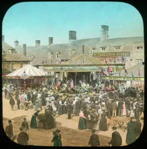 Prints of Witney, Oxfordshire. Carousels at Witney Fair, with crowds watching the fun. Hand-tinted lantern slide photographed by Henry Taunt 1890s Oxfordshire Prints: Witney Fair Print, a hand-tinted lantern slide photograph