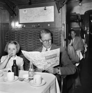 Train Journey Print: Man and Girl Seated with Refreshments