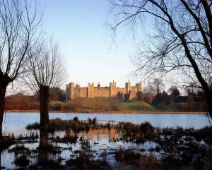 Prints of FRAMLINGHAM CASTLE, Suffolk. View of the castle across the mere Suffolk Prints: Framlingham Castle Print: View Across the Mere