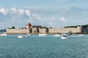 Prints of PORTCHESTER CASTLE, Hampshire.The Watergate and Roman Walls, seen from across the harbour. General view from the east Hampshire Prints: Portchester Castle Print - Watergate and Roman Walls