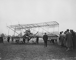 <b class=qtipBold><figcaption>Farman Biplane EGP_22662_53</figcaption></b><br>A group of men watching as two men take their seats in a Farman biplane at Bournemouth in 1910. The pilot has been identified as Claude Graham-White, pioneer of aerial reconnaissance. From the EGPN Collection held by Historic England Archive.<br><em>© Historic England</em> Farman Biplane EGP_22662_53