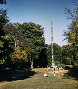 Prints of Windsor Great Park, Totem Pole, Runnymede, Surrey. The Totem Pole in Windsor Great Park, viewed from the south-west, with people gathered around it Sculpture Prints: Print of Totem Pole in Windsor Great Park, viewed from the south-west