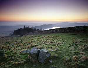 <b class=qtipBold><figcaption>Hadrian's Wall J080006</figcaption></b><br>HADRIAN'S WALL, Northumberland. Hotbank Crags, near turret 37B. The sun sets behind the wall showing Crag Lough and Highshields Crags in the distance. hadrian<br><em>© Historic England</em> Hadrian's Wall J080006