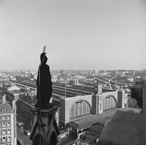 Prints of KINGS CROSS STATION, London. Looking towards the railway station from the roof of the St. Pancras Hotel with statue of Britannia in the foreground. Photographed by John Gay. Date range: 1960 - 1972 Transport Prints: Print of Kings Cross Station from the St. Pancras Hotel roof