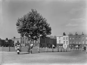 Prints of CUMBERLAND MARKET, REGENTS PARK, CAMDEN, GREATER LONDON. A view looking north-east across Cumberland Market towards Edward Street and terraced houses and vacant shops on the east side of the square Cumberland Prints: Cumberland Market Print, a 1930s photograph of Camden, London