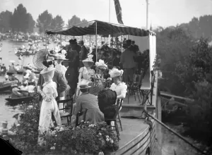 Print of men and women taking tea on a college barge at Henley Regatta