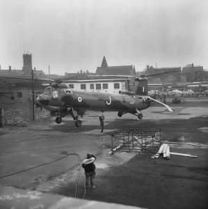 A colour print of a RAF Belvedere helicopter above Coventry Cathedral