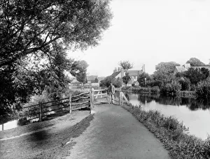 <b class=qtipBold><figcaption>Kennet towpath CC97_02774</figcaption></b><br>GREENHAM, Newbury, Berkshire. Looking east from beyond the wharf along the Kennet towpath, with a man passing through the gate ahead. Photographed in 1890 by Henry Taunt.<br><em>© Historic England</em> Kennet towpath CC97_02774