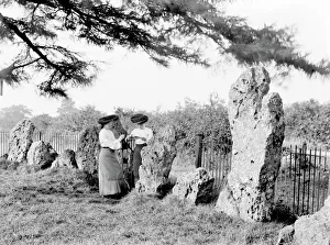 <b class=qtipBold><figcaption>The Kings Men CC72_02440</figcaption></b><br>The Kings Men, Rollright Stones, Oxfordshire. Two women in Edwardian dress near the largest stone in the circle. Legend states that the monument was formed when a king and his army were turned to stone by a witch. The site is made up of 3 different monuments all believed to date from 2500-2000 BC.<br><em>© Historic England Archive</em> The Kings Men CC72_02440