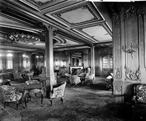 <b class=qtipBold><figcaption>Lounge, RMS Olympic BL24990_005</figcaption></b><br>Looking forward in the lounge, RMS Olympic, White Star Line, 1920-21. The Olympic was sister ship to the ill-fated Titanic and Britannic. This Bedford Lemere and Company photograph was commissioned by the White Star Line, which was also known as the Oceanic Steam Navigation Company, and was probably taken at Southampton docks.<br><em>© Historic England Archive</em> Lounge, RMS Olympic BL24990_005