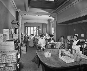 <b class=qtipBold><figcaption>National Food Fund BL22913_002</figcaption></b><br>National Food Fund building on Dover Street, Westminster. The National Food Fund processed donated food to feed thousands of Belgian war refugees. Women packing groceries. Bedford Lemere, 1915.<br><em>© Historic England</em> National Food Fund BL22913_002